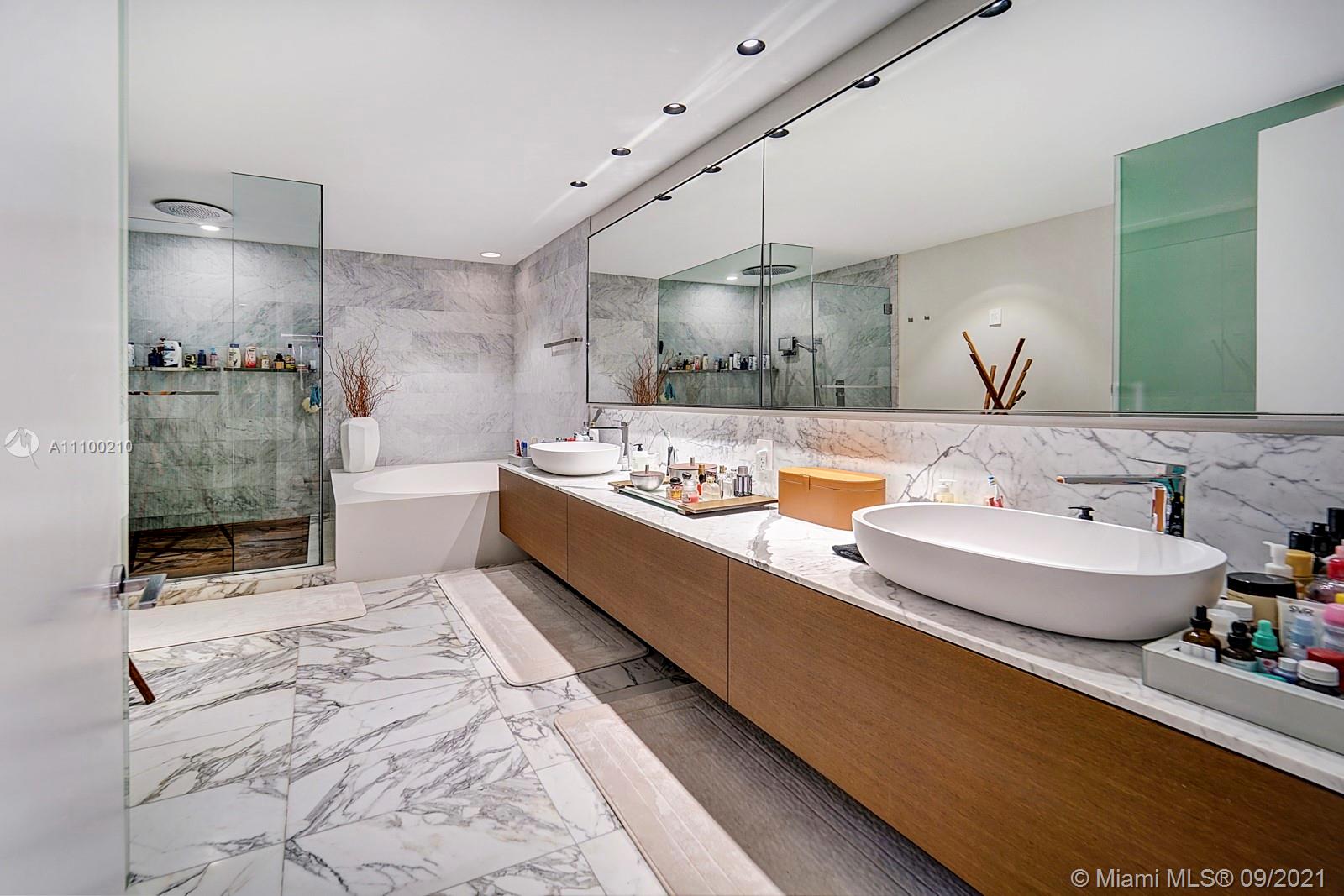 10203 Collins Avenue, Unit 1802 Bal Harbour, FL 33154 - Photo 29 of 43 a bathroom with a tub sink and mirror