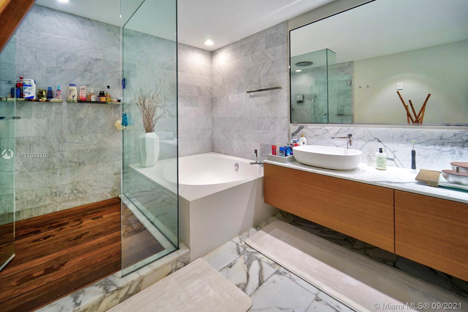 10203 Collins Avenue, Unit 1802 Bal Harbour, FL 33154 - Photo 30 of 43 a bathroom with a double vanity sink mirror and bathtub