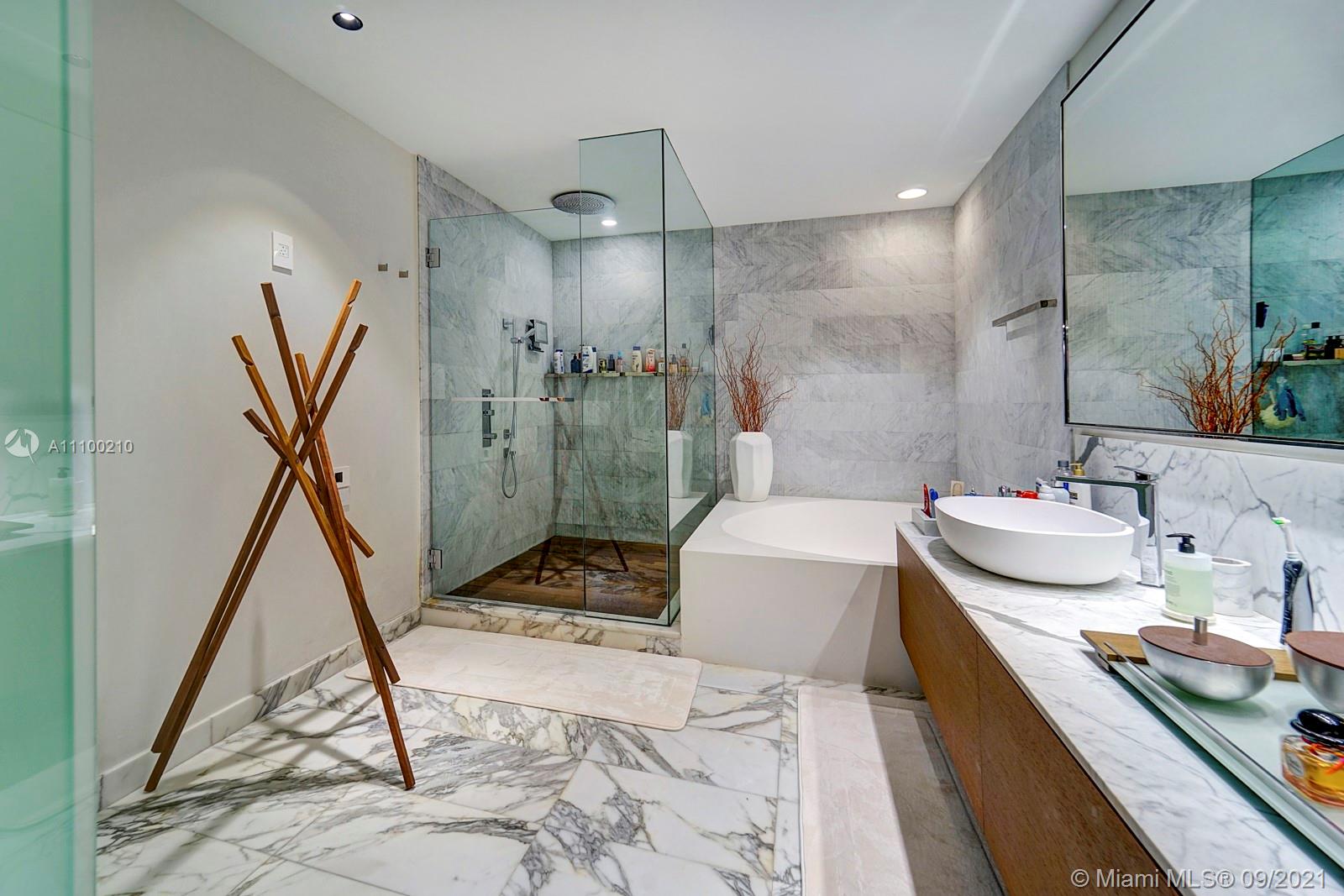 10203 Collins Avenue, Unit 1802 Bal Harbour, FL 33154 - Photo 31 of 43 a bathroom with a sink tub and a shower