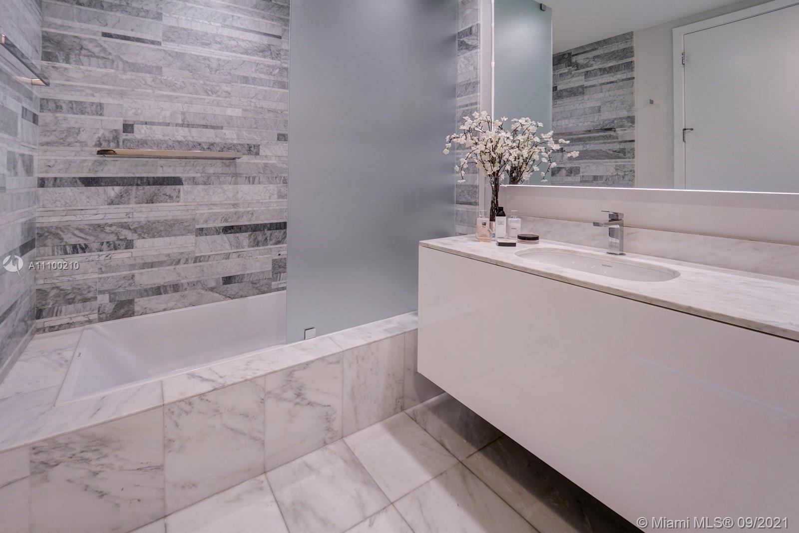 10203 Collins Avenue, Unit 1802 Bal Harbour, FL 33154 - Photo 34 of 43 a bathroom with a sink and a bathtub