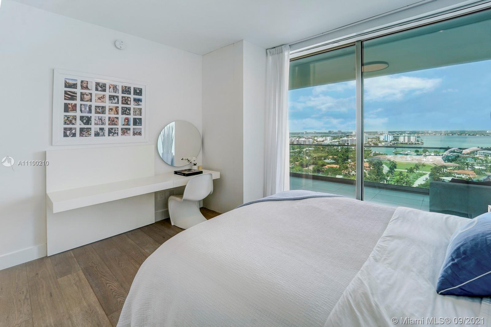 10203 Collins Avenue, Unit 1802 Bal Harbour, FL 33154 - Photo 35 of 43 a bedroom with a bed and large window
