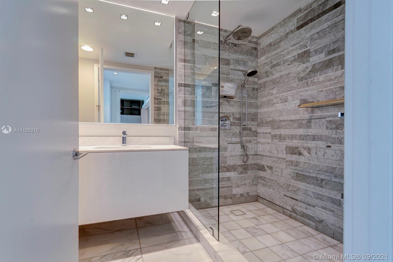 10203 Collins Avenue, Unit 1802 Bal Harbour, FL 33154 - Photo 38 of 43 a bathroom with a shower sink and mirror