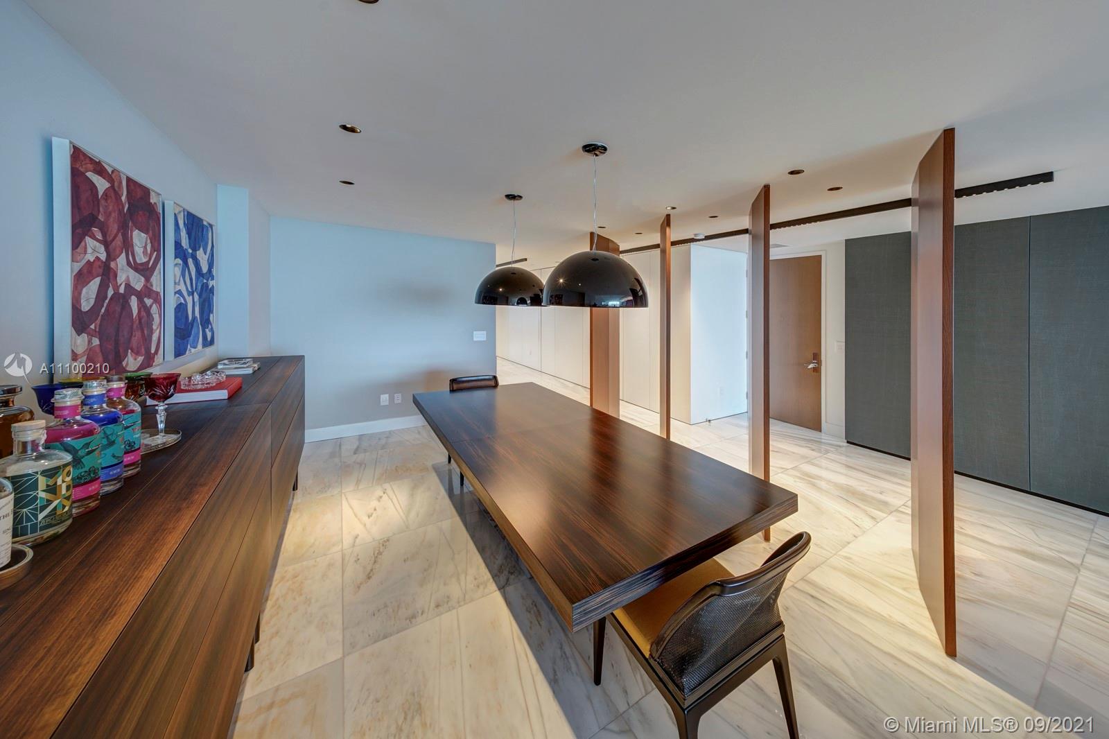 10203 Collins Avenue, Unit 1802 Bal Harbour, FL 33154 - Photo 7 of 43 a view of a dining room with furniture and wooden floor