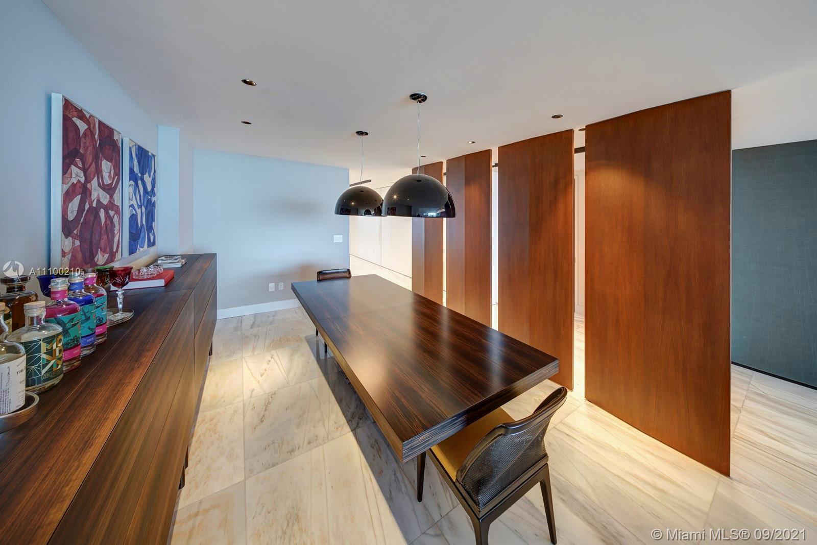 10203 Collins Avenue, Unit 1802 Bal Harbour, FL 33154 - Photo 9 of 43 a living room with table
