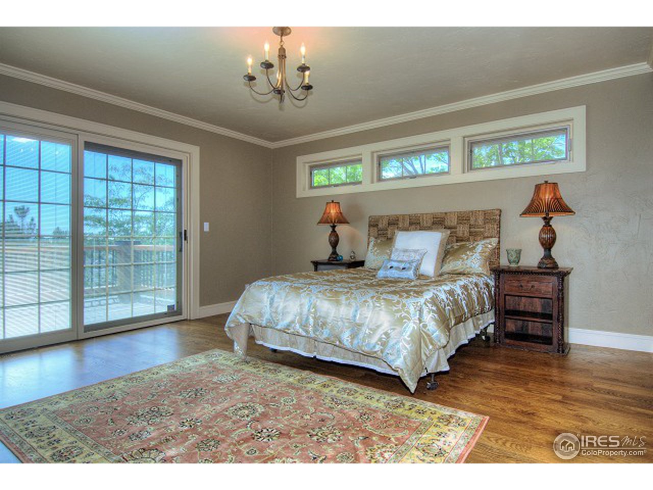 3850 Spring Valley Road Boulder, CO 80304 - Photo 14 of 25 a bedroom with a bed and wooden floor