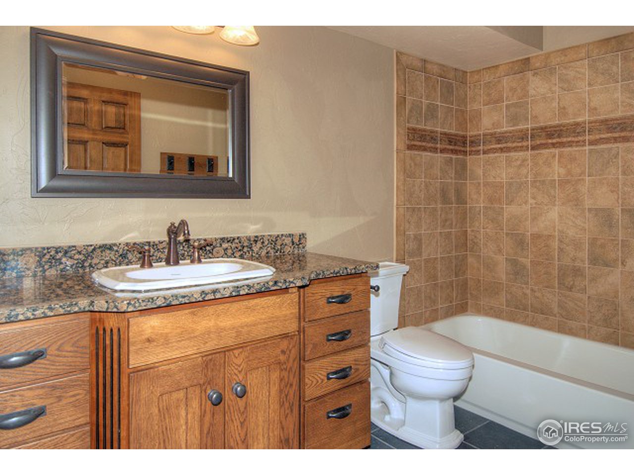 3850 Spring Valley Road Boulder, CO 80304 - Photo 18 of 25 a bathroom with a granite countertop sink toilet and shower