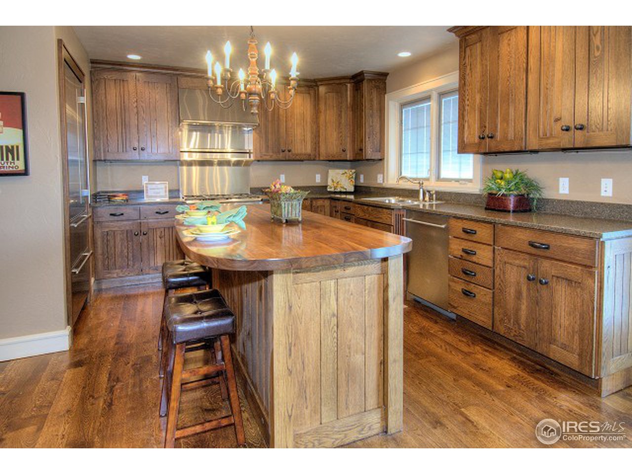 3850 Spring Valley Road Boulder, CO 80304 - Photo 4 of 25 a kitchen with stainless steel appliances kitchen island granite countertop a sink a stove a dining table and chairs
