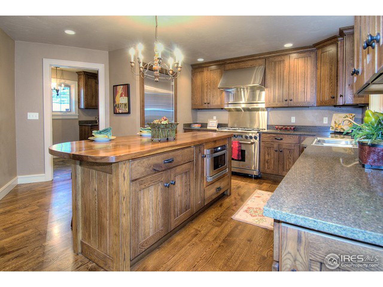 3850 Spring Valley Road Boulder, CO 80304 - Photo 5 of 25 a kitchen with kitchen island granite countertop a sink stove and wooden cabinets