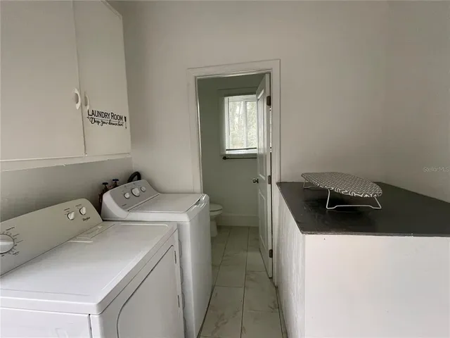 a utility room with dryer and washer