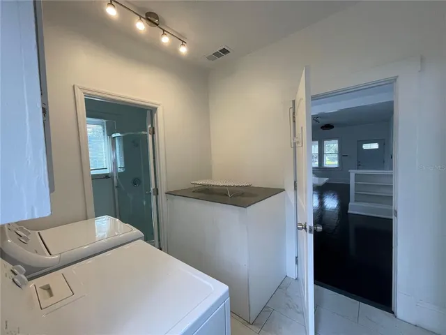 a kitchen with a refrigerator and sink