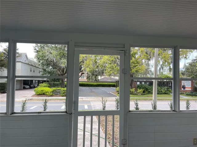 a view of a glass door with a street from a balcony