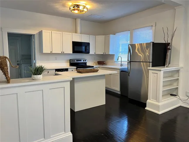 a kitchen with cabinets a sink and a stainless steel appliances