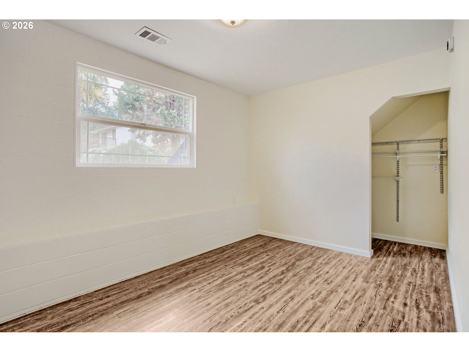 14539 Southeast Center Street Portland, OR 97236 - Photo 21 of 30 an empty room with wooden floor and windows
