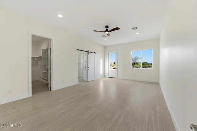 a spacious bathroom with a granite countertop sink and a mirror