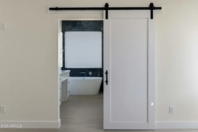 a kitchen with kitchen island white cabinets and stainless steel appliances