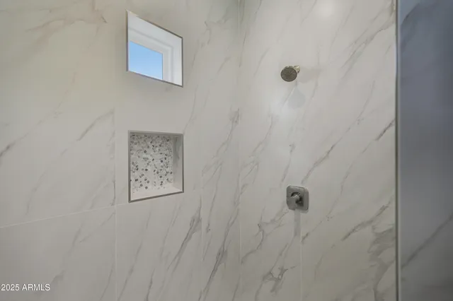 a large kitchen with stainless steel appliances kitchen island granite countertop a refrigerator a stove and a sink with wooden floor