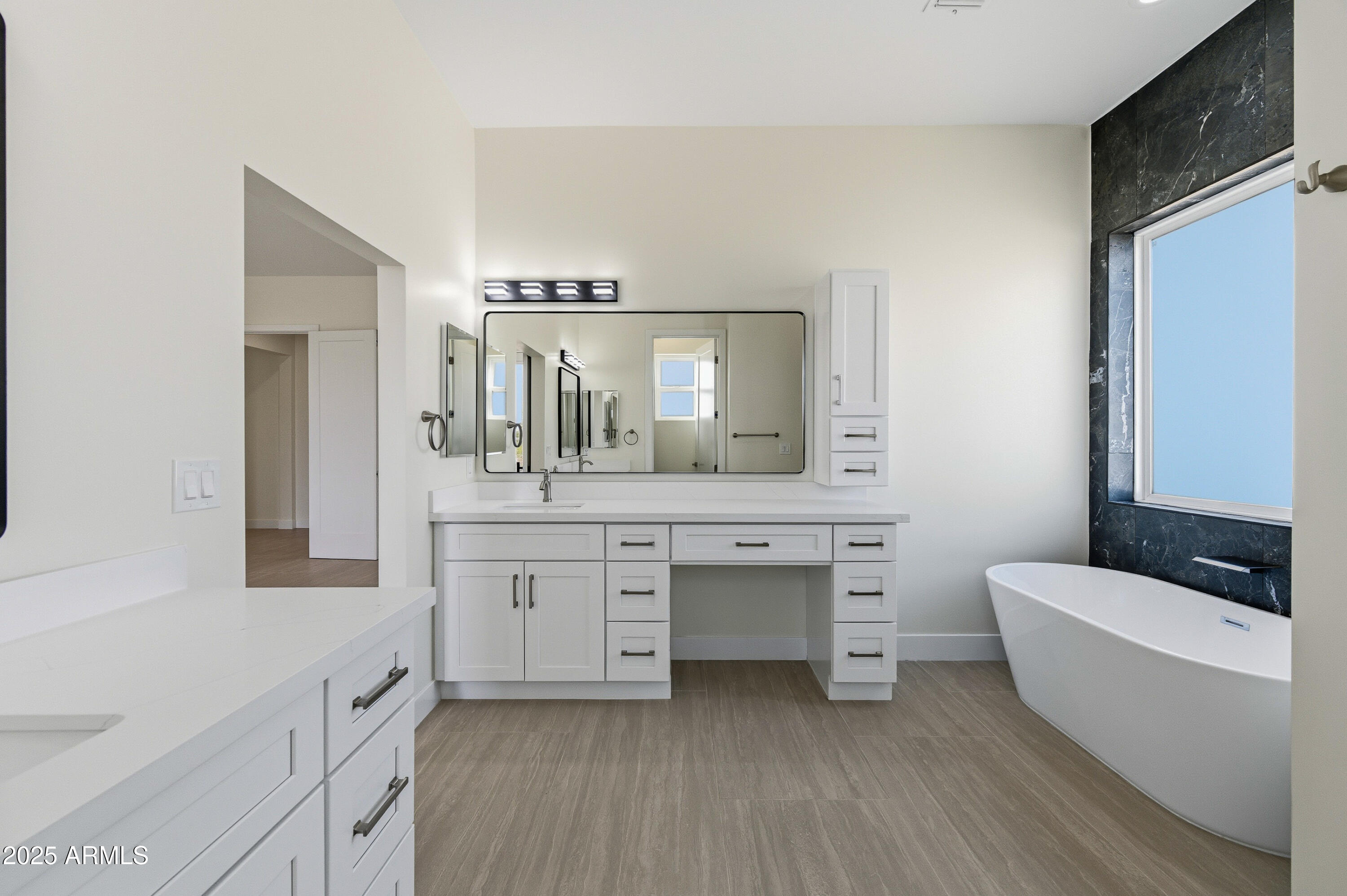 10039 North Burris Road Casa Grande, AZ 85122 - Photo 36 of 61 a bathroom with a double vanity sink a mirror and a bathtub