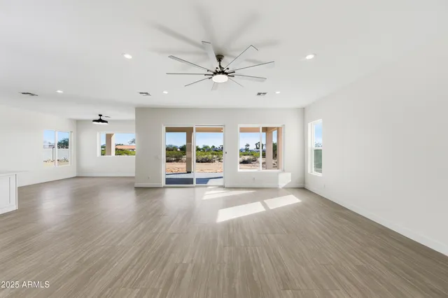 an empty room with wooden floor and mirror