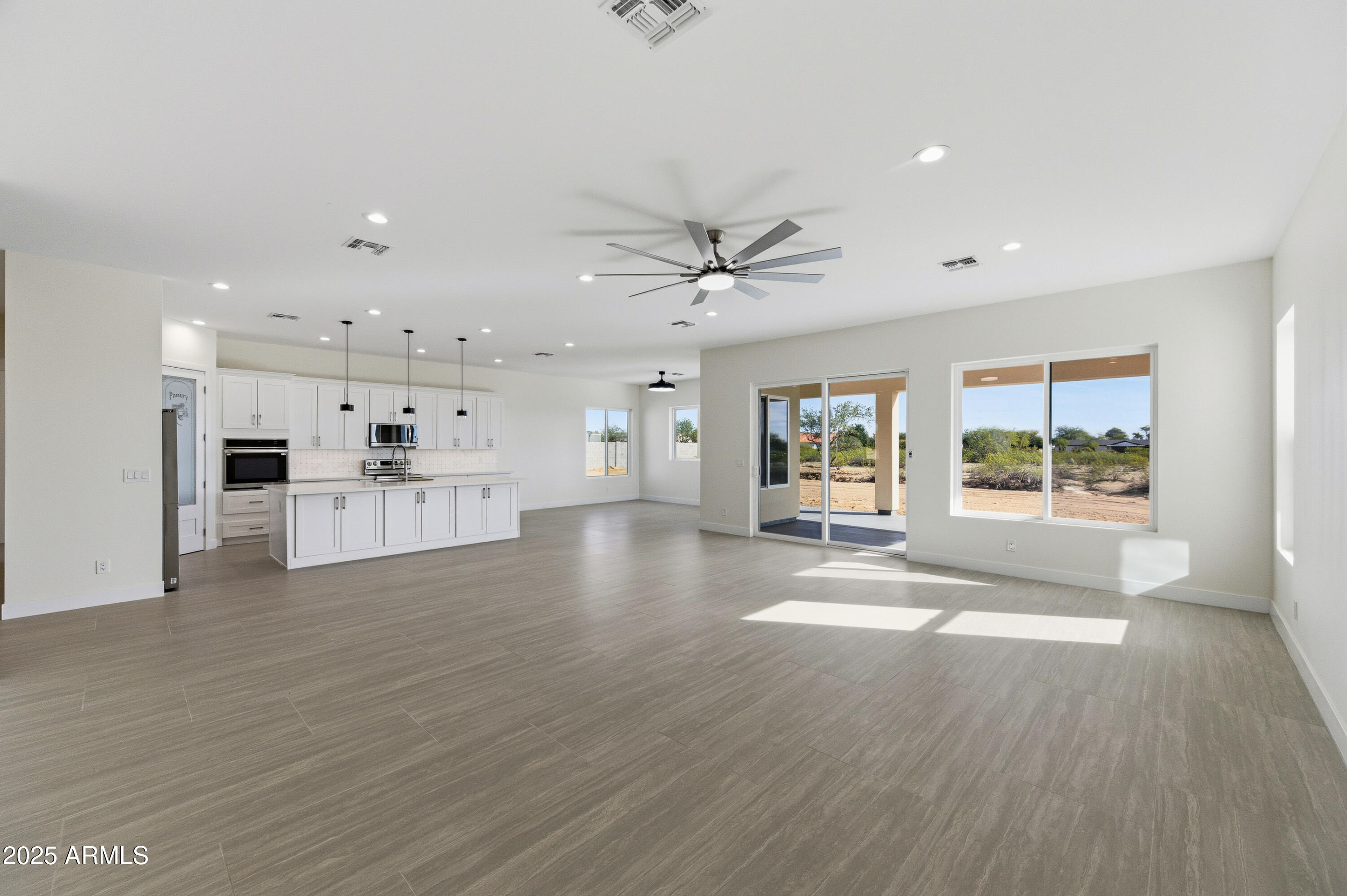 10039 North Burris Road Casa Grande, AZ 85122 - Photo 47 of 61 a view of an empty room with wooden floor and a window