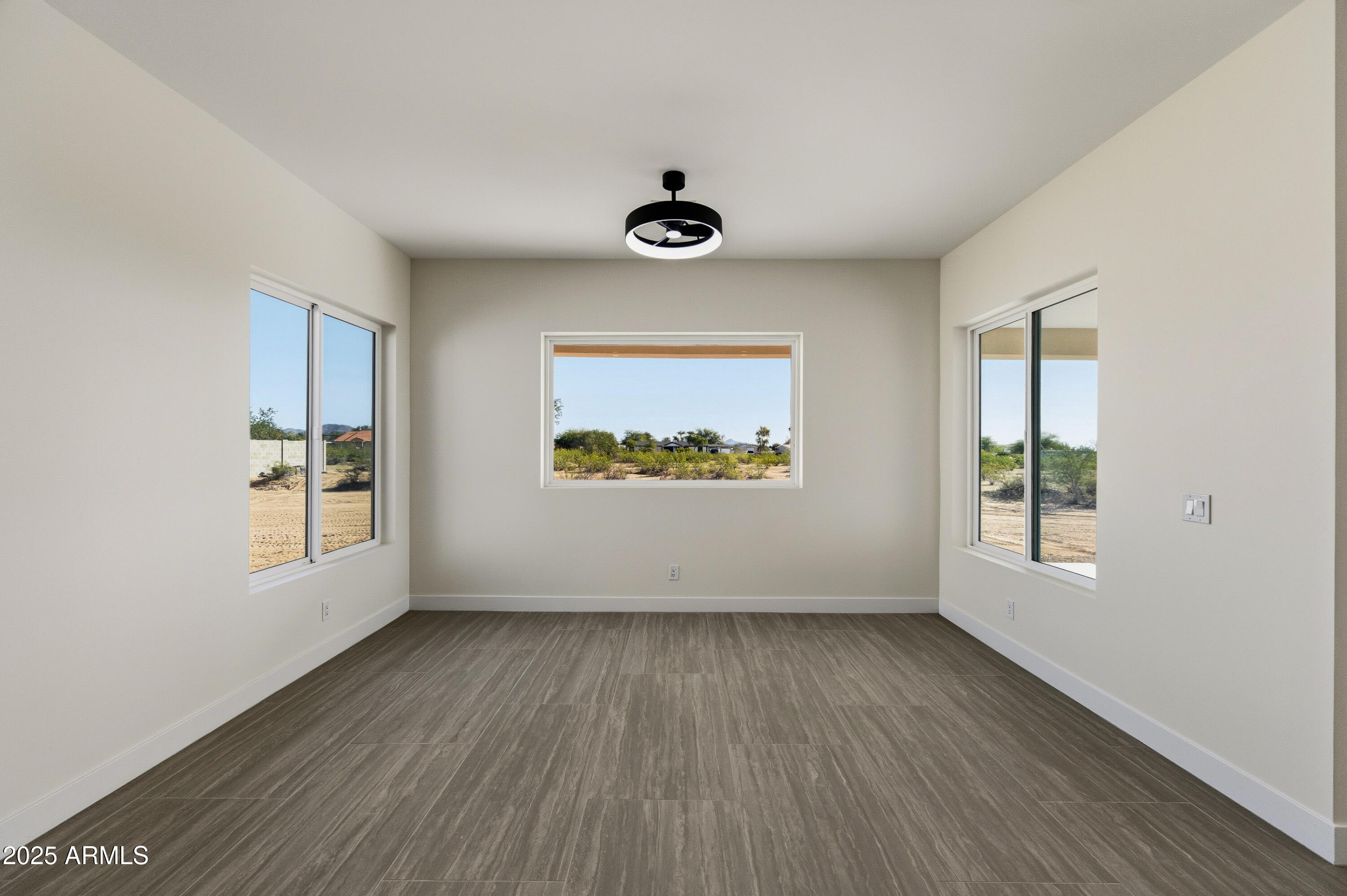 10039 North Burris Road Casa Grande, AZ 85122 - Photo 49 of 61 an empty room with wooden floor and windows