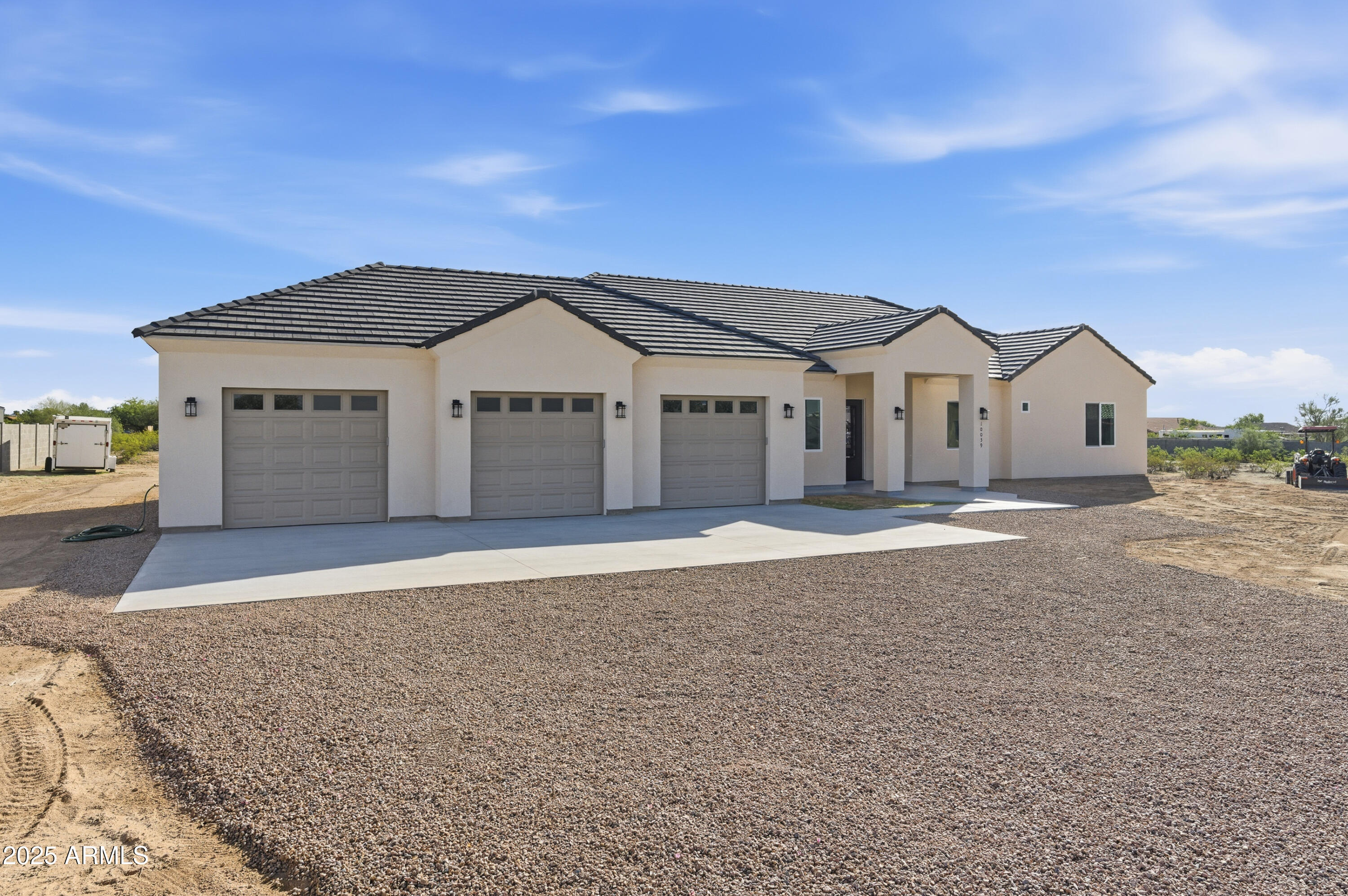 10039 North Burris Road Casa Grande, AZ 85122 - Photo 8 of 61 a front view of a house with a yard and garage