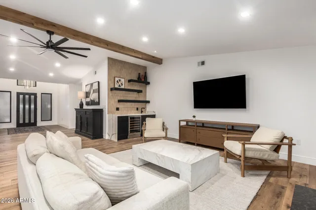 a living room with furniture a rug and a large window