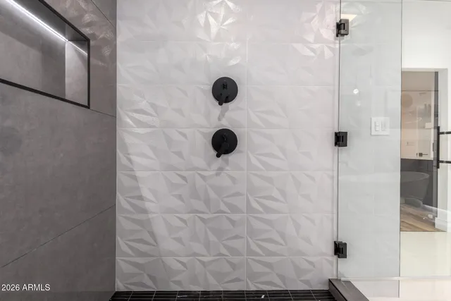 a bathroom with a tub shower and toilet