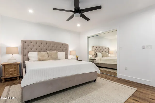 a large bedroom with a bed and a large window