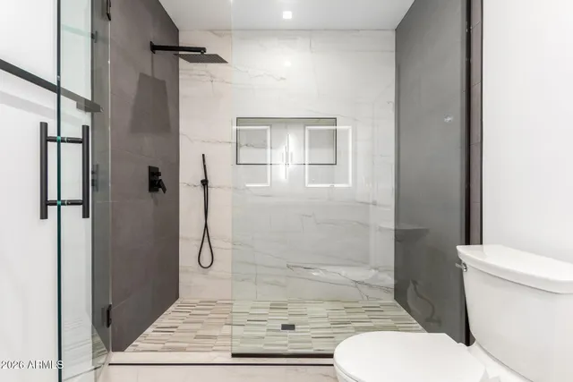 a bathroom with a granite countertop sink double and mirror