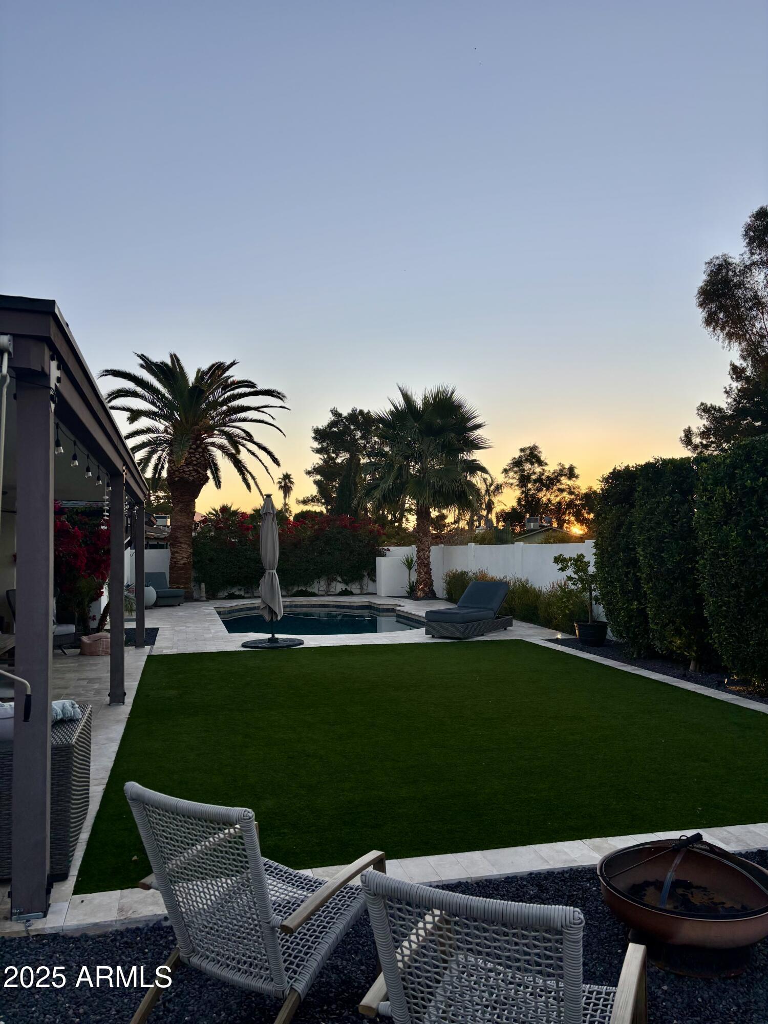 6533 East Phelps Road Scottsdale, AZ 85254 - Photo 4 of 6 a view of a big yard with potted plants and a fountain