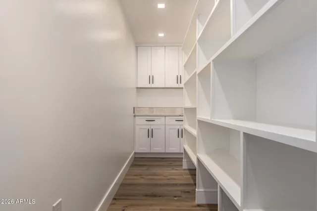 a kitchen with a sink stainless steel appliances and white cabinets