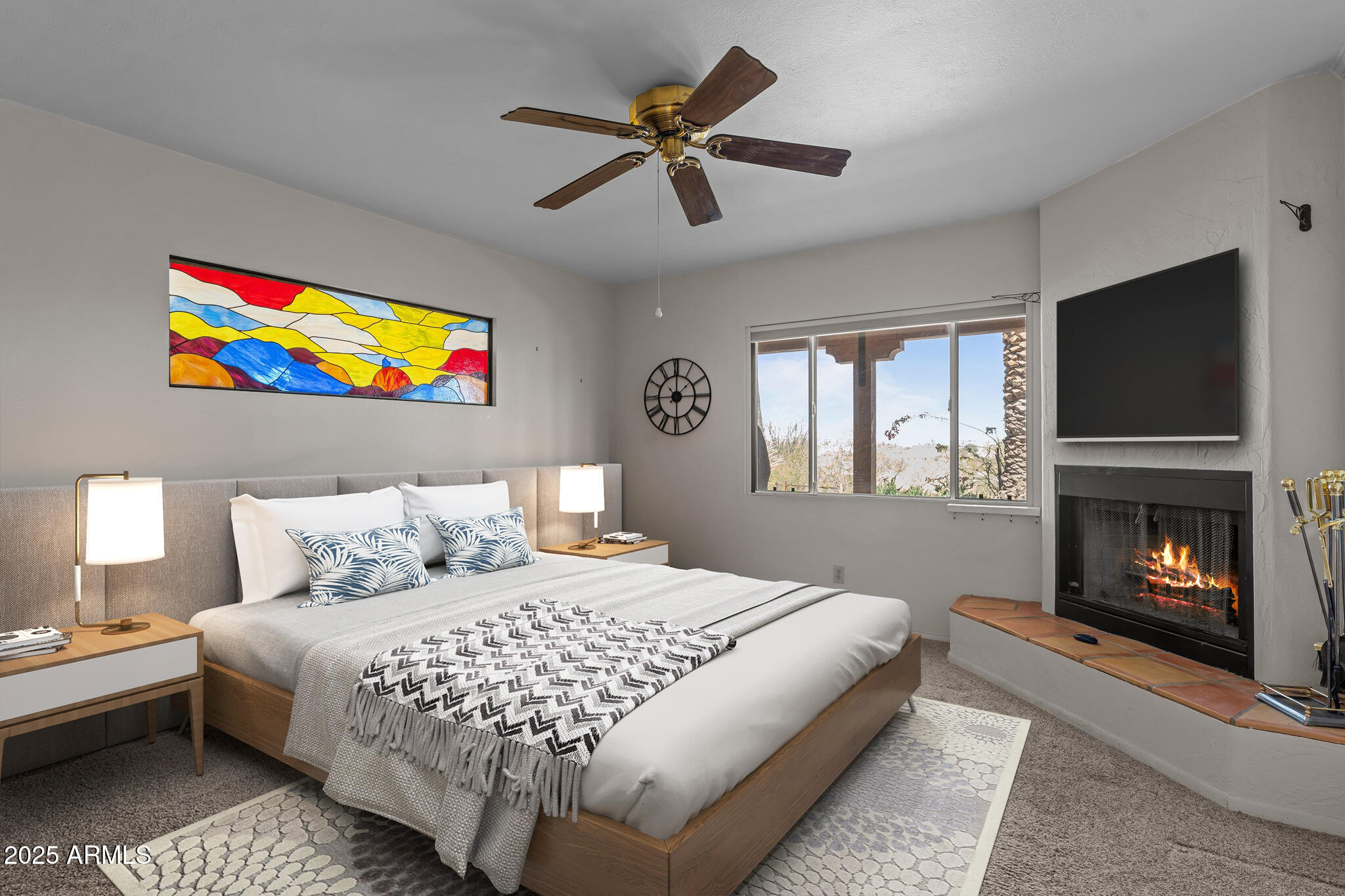 651 Chaparral Road Wickenburg, AZ 85390 - Photo 11 of 58 a bedroom with a bed and a fireplace