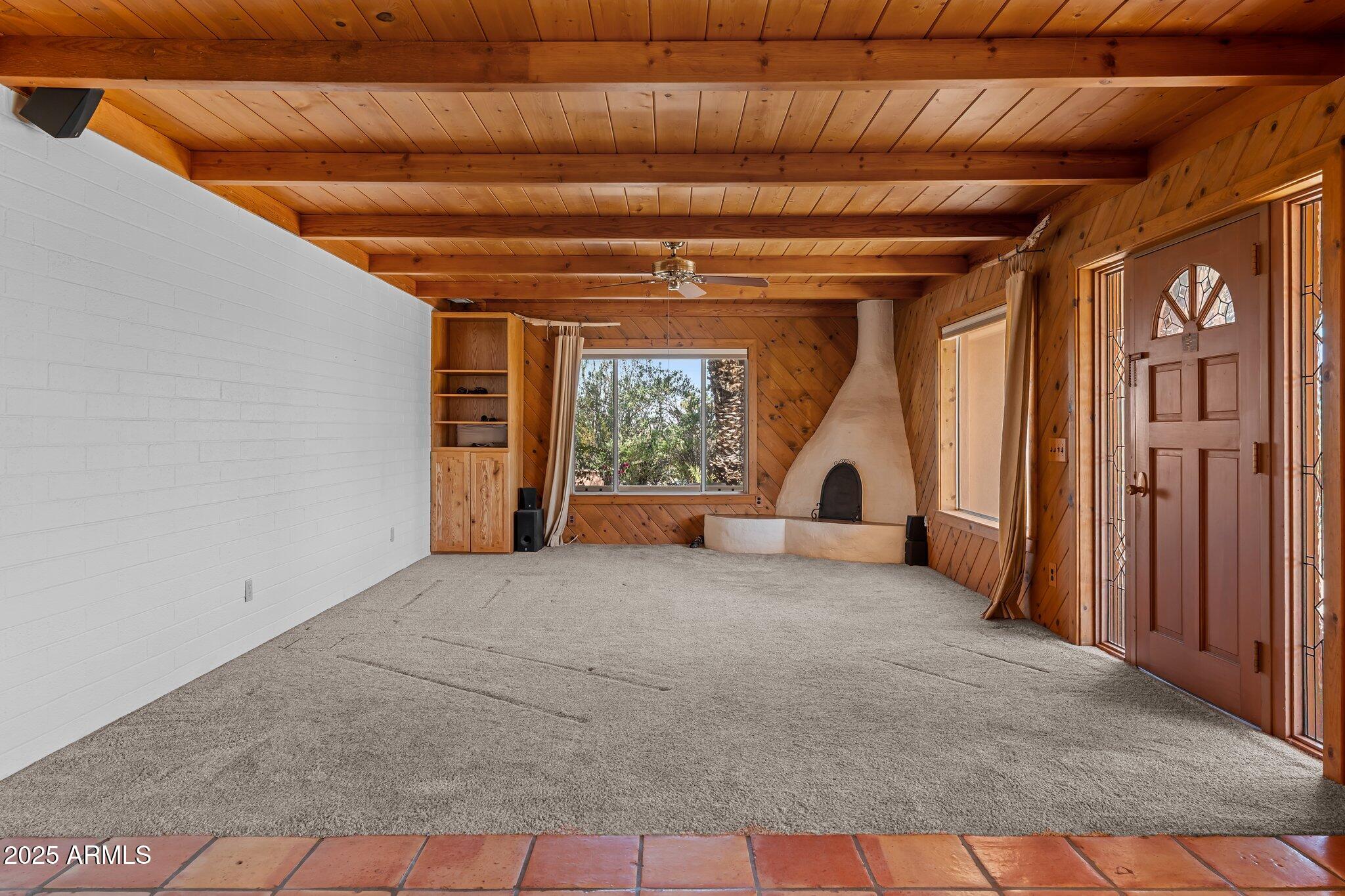 651 Chaparral Road Wickenburg, AZ 85390 - Photo 18 of 58 a view of an empty room with a fireplace and windows
