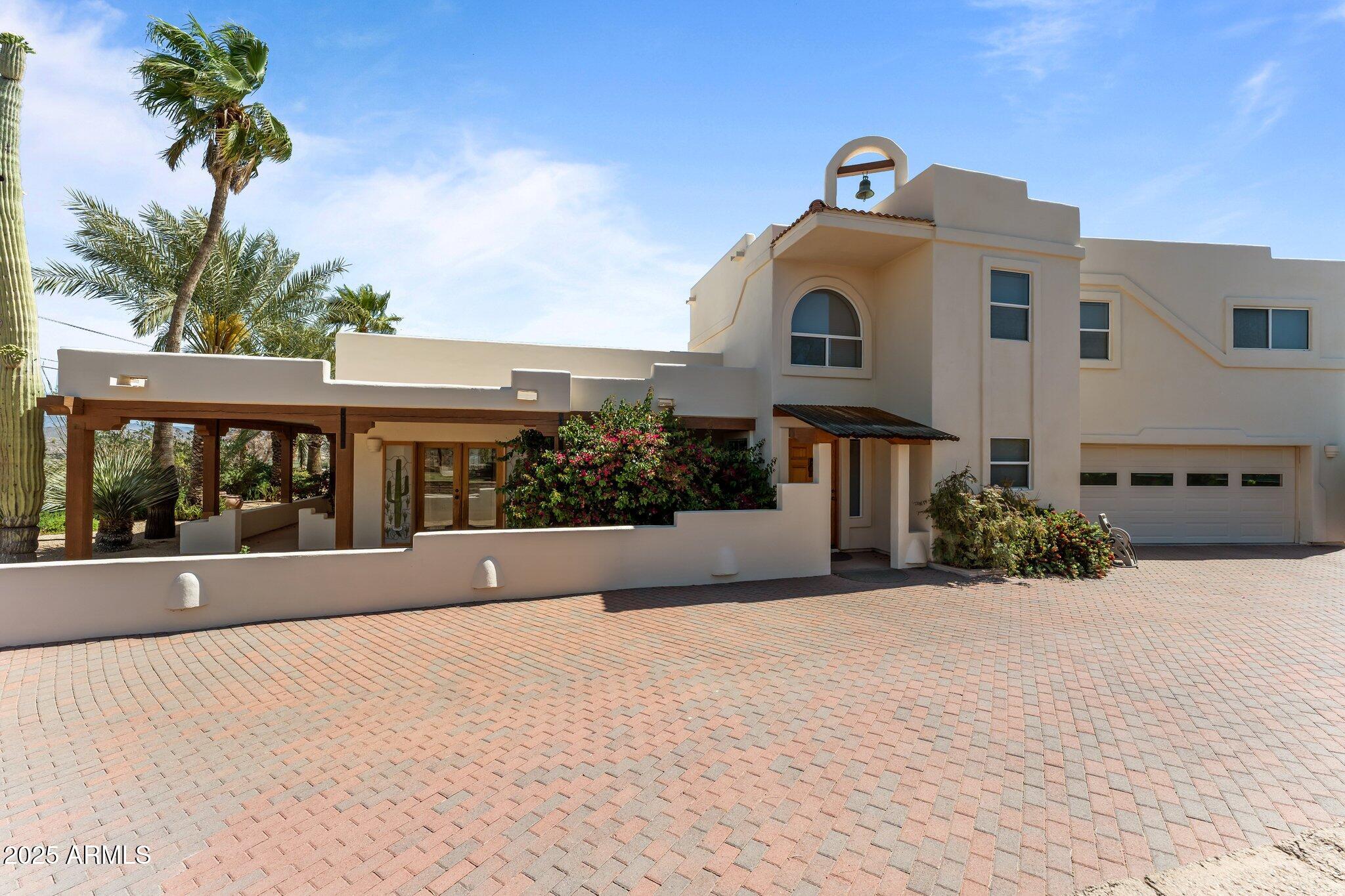 651 Chaparral Road Wickenburg, AZ 85390 - Photo 2 of 58 a front view of a house with a yard
