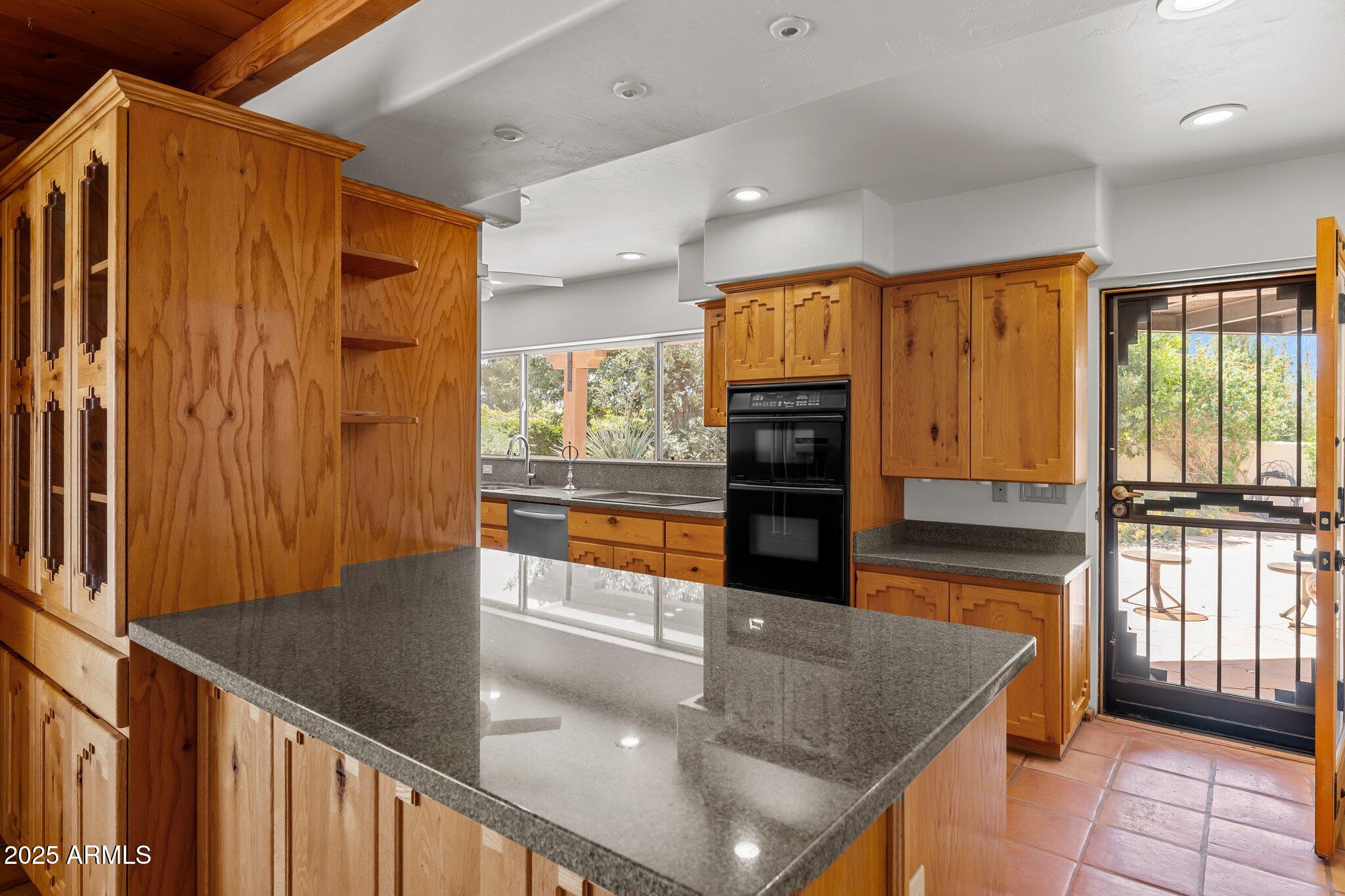 651 Chaparral Road Wickenburg, AZ 85390 - Photo 21 of 58 a view of a living room and floor to ceiling window kitchen