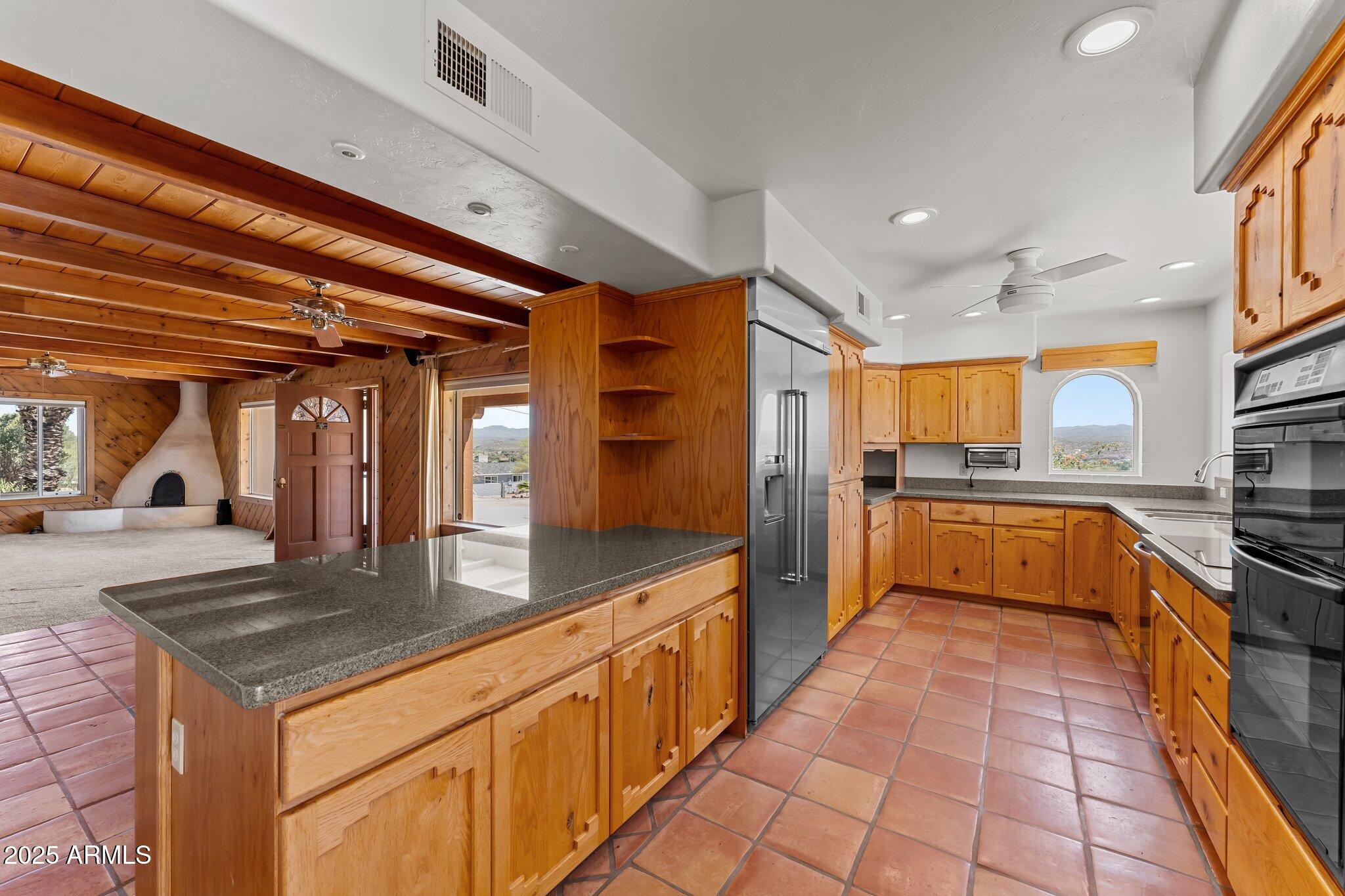 651 Chaparral Road Wickenburg, AZ 85390 - Photo 23 of 58 a large kitchen with stainless steel appliances granite countertop a stove and cabinets