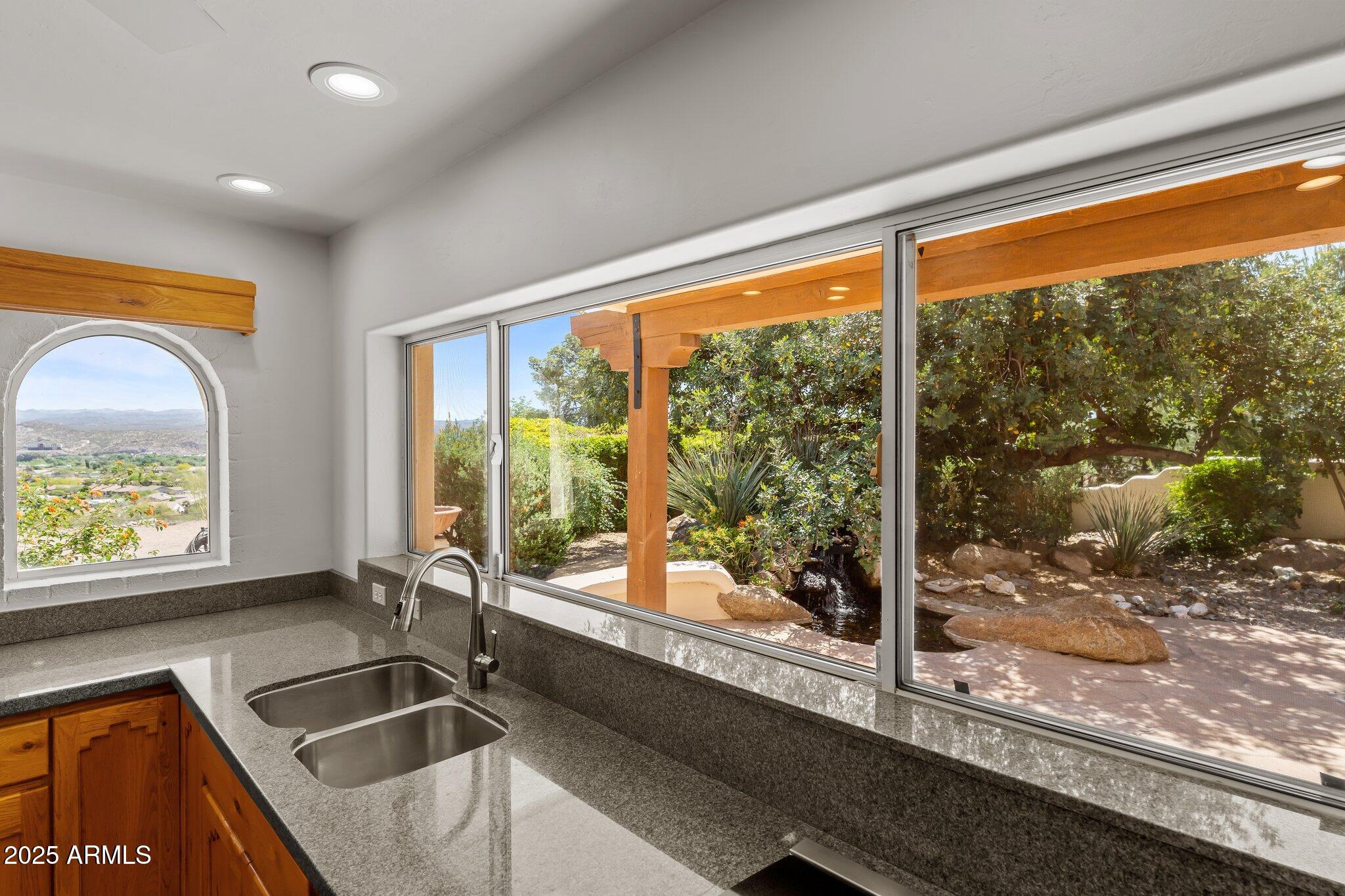 651 Chaparral Road Wickenburg, AZ 85390 - Photo 24 of 58 a kitchen with a sink and a large window
