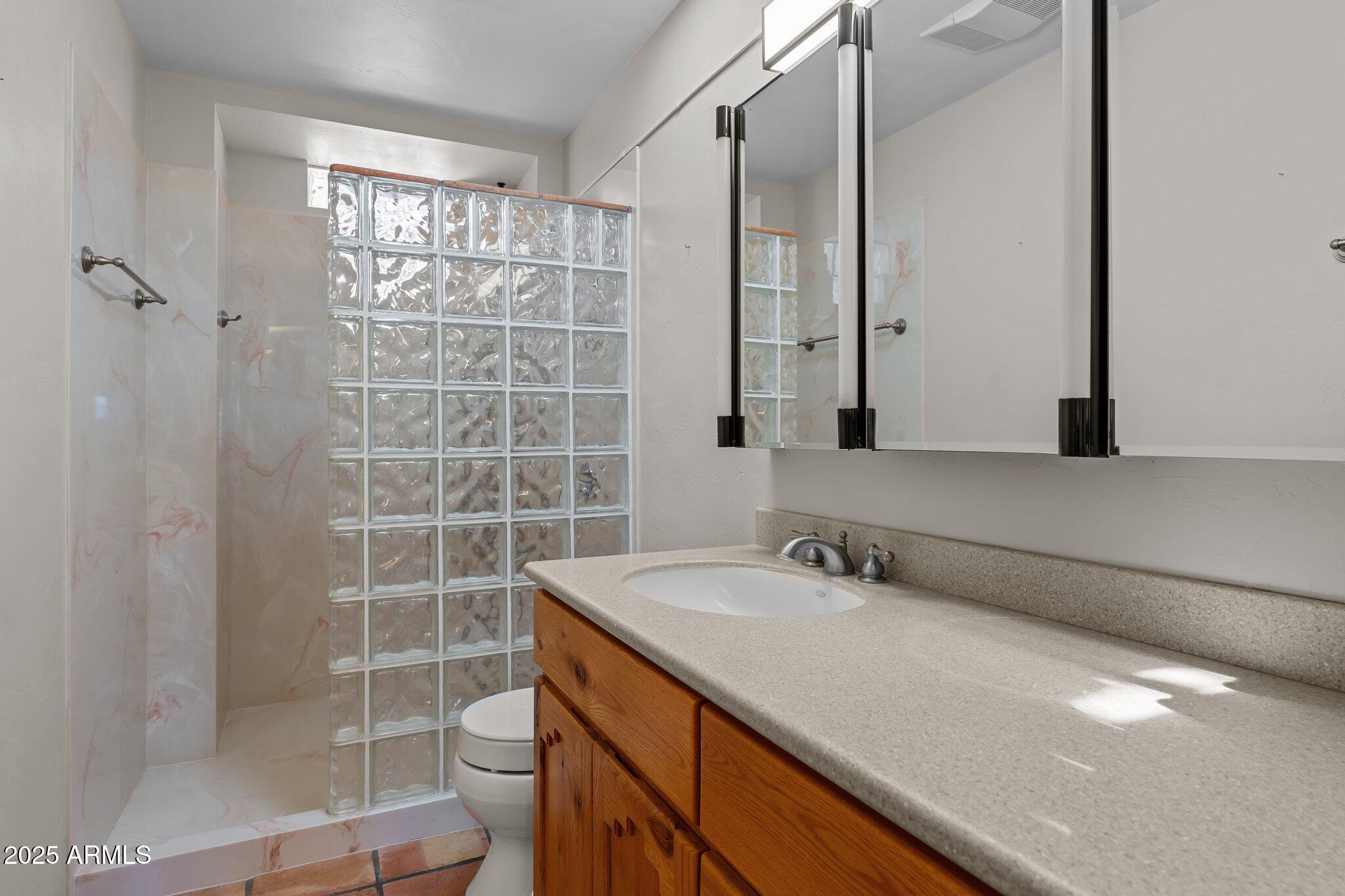 651 Chaparral Road Wickenburg, AZ 85390 - Photo 28 of 58 a bathroom with a sink a toilet and shower