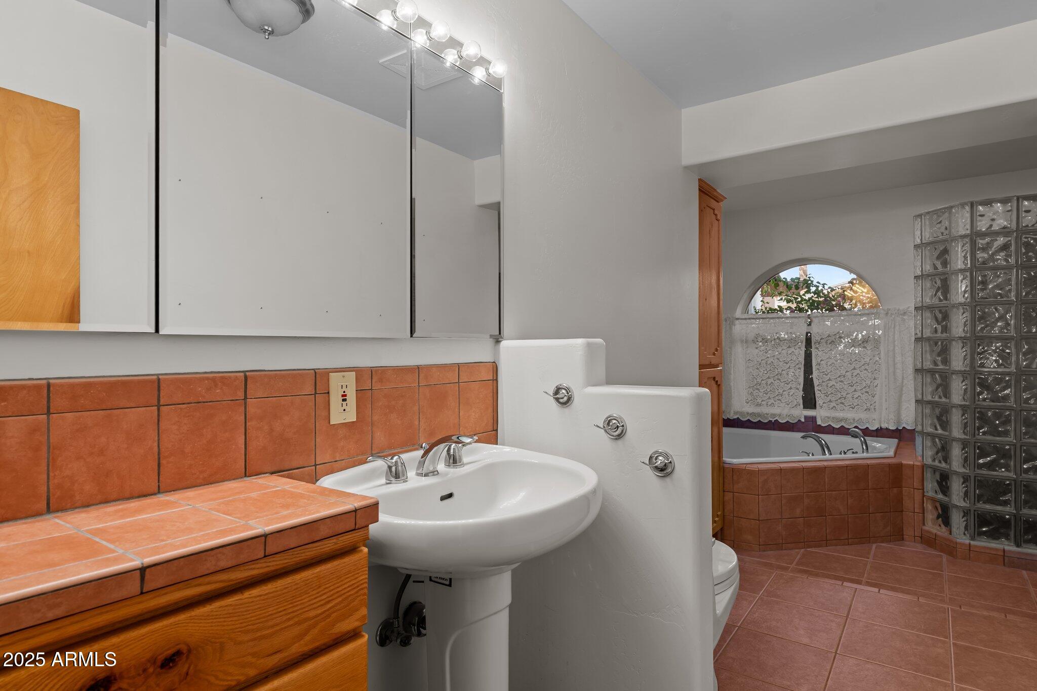 651 Chaparral Road Wickenburg, AZ 85390 - Photo 30 of 58 a bathroom with a sink a toilet and shower