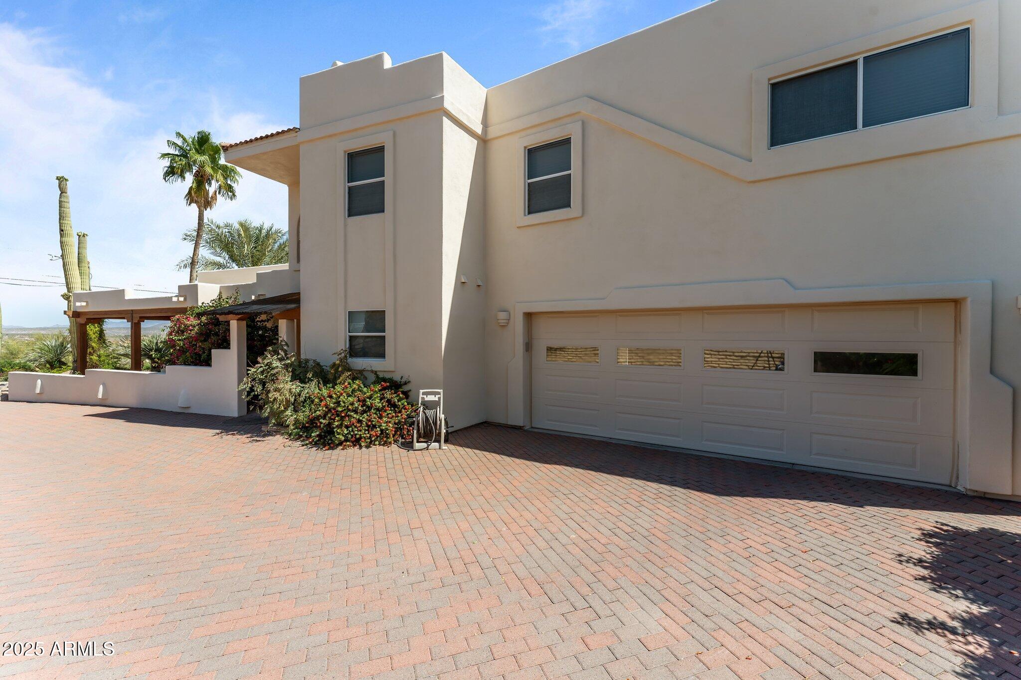 651 Chaparral Road Wickenburg, AZ 85390 - Photo 3 of 58 a view of a house with a yard and potted plants