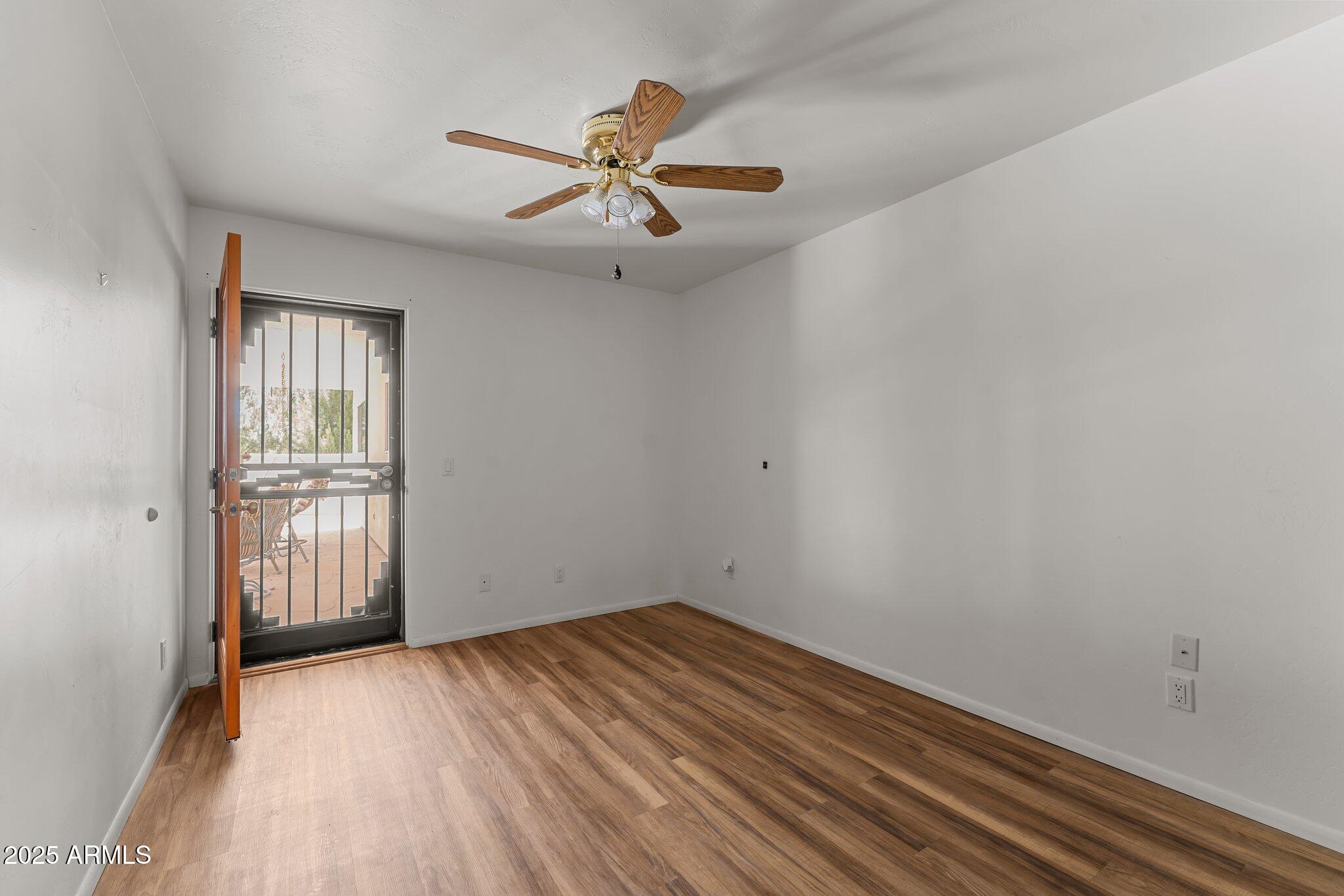 651 Chaparral Road Wickenburg, AZ 85390 - Photo 34 of 58 wooden floor in an empty room with a window
