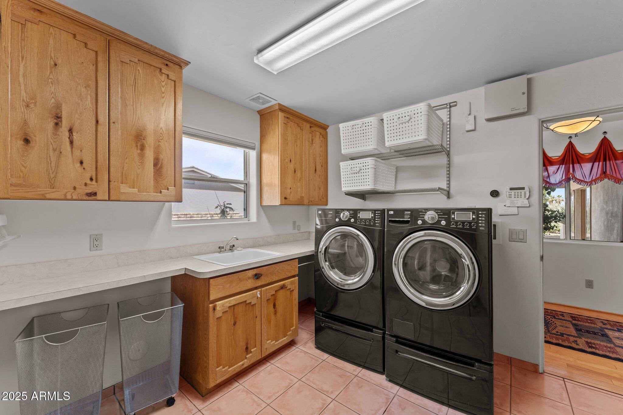 651 Chaparral Road Wickenburg, AZ 85390 - Photo 35 of 58 a utility room with sink dryer and washer