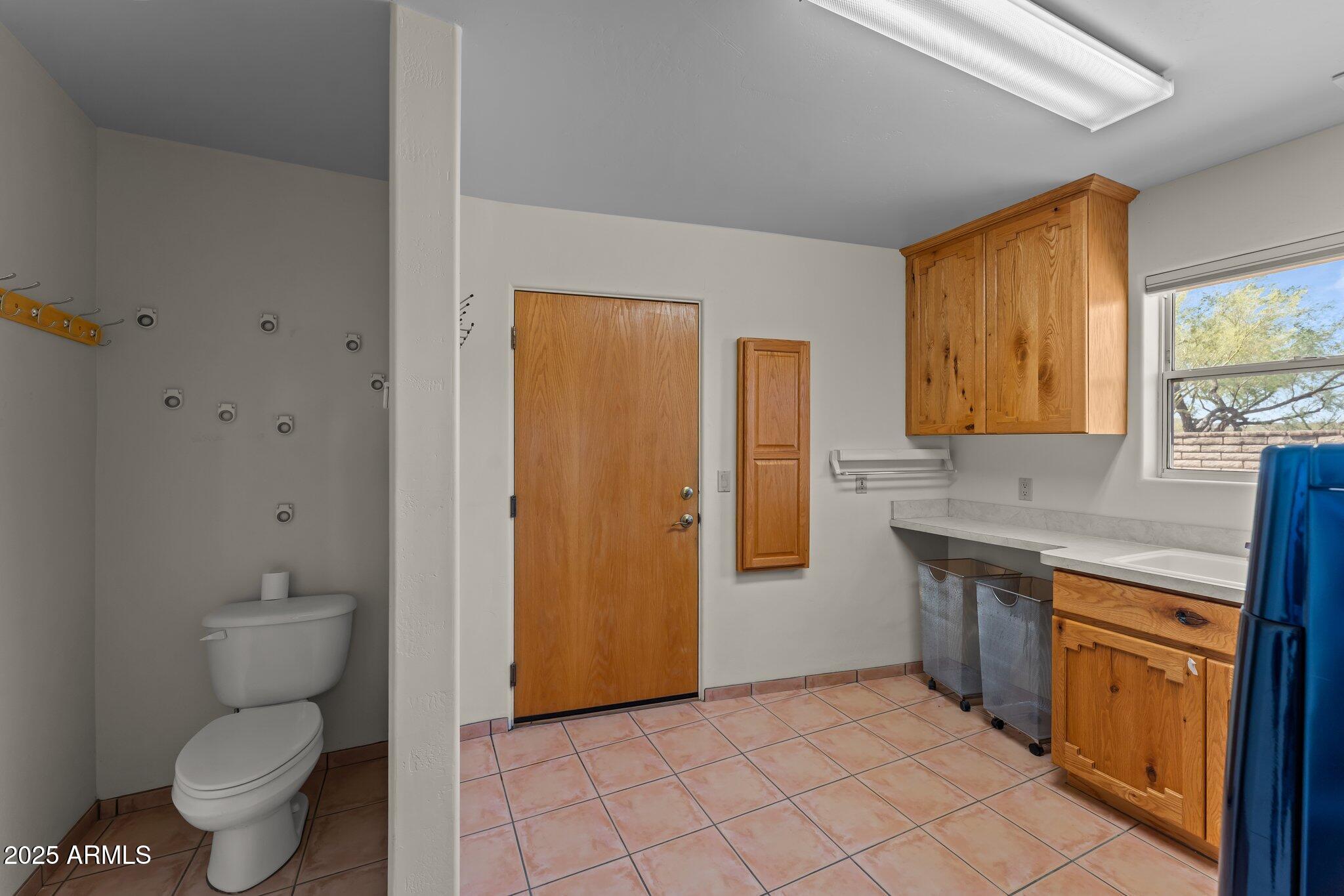 651 Chaparral Road Wickenburg, AZ 85390 - Photo 37 of 58 a spacious bathroom with a granite countertop toilet sink and mirror