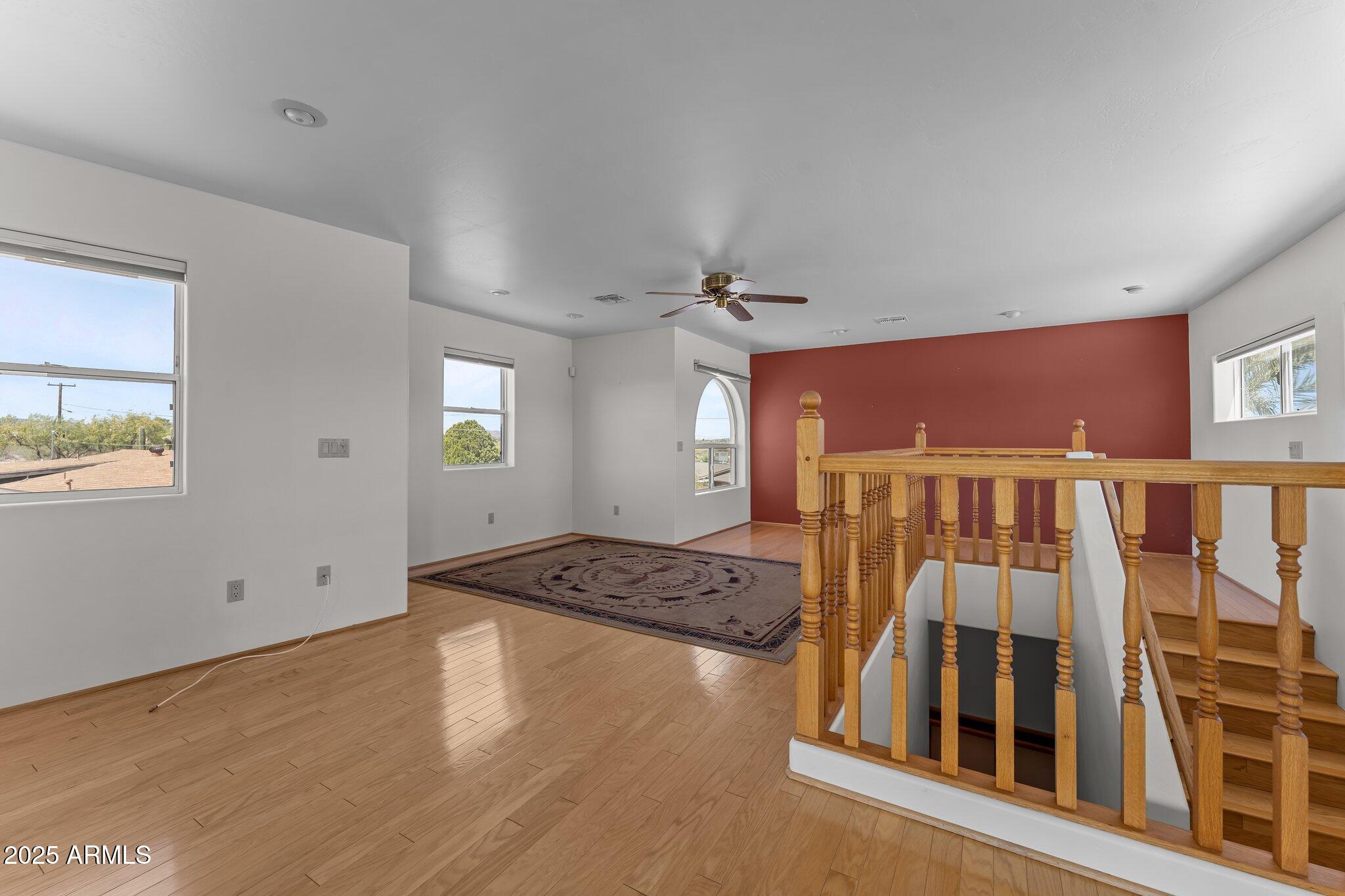 651 Chaparral Road Wickenburg, AZ 85390 - Photo 40 of 58 a view of an empty room with window and wooden floor