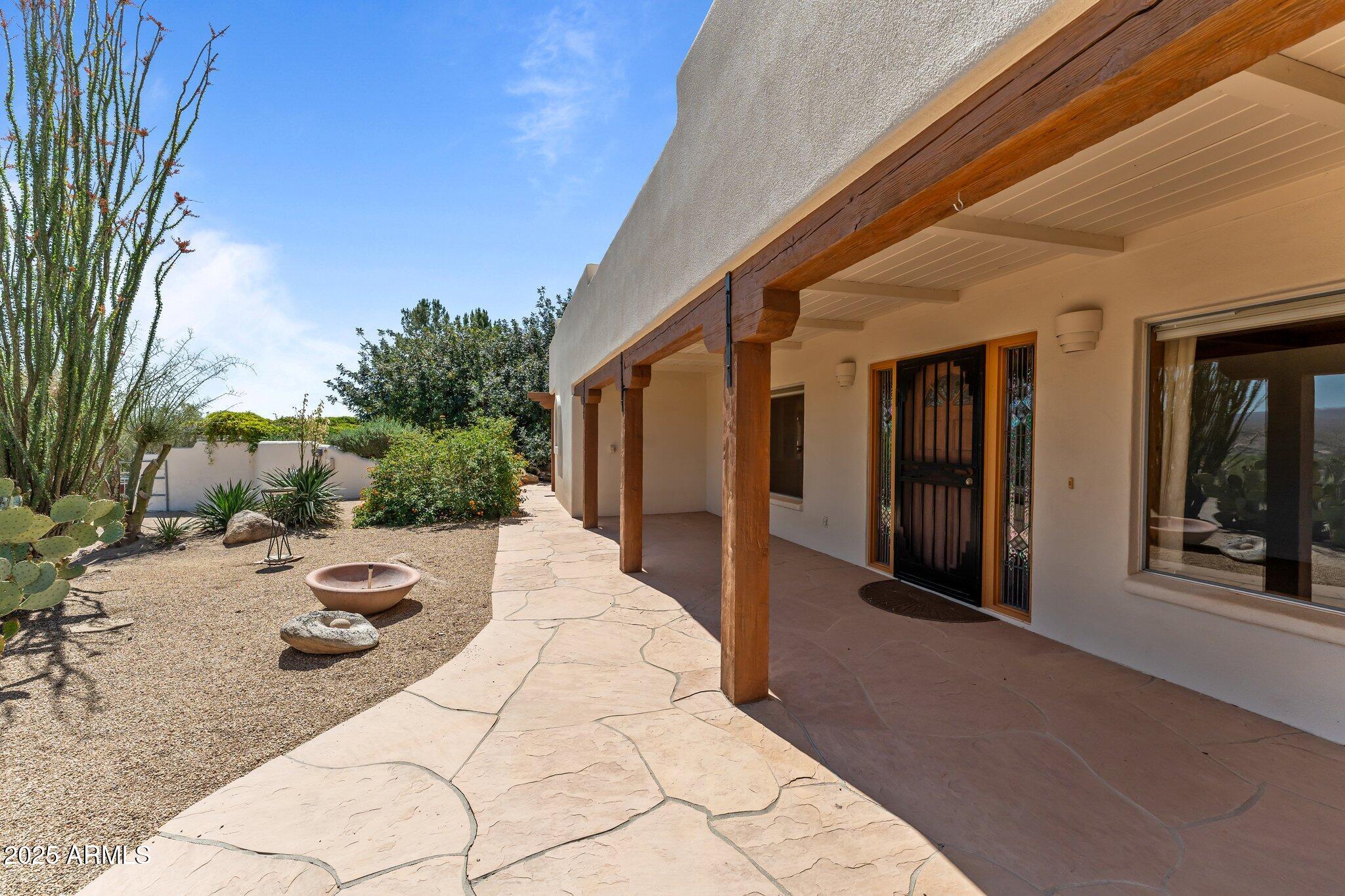 651 Chaparral Road Wickenburg, AZ 85390 - Photo 48 of 58 a view of a porch with furniture and floor to ceiling window