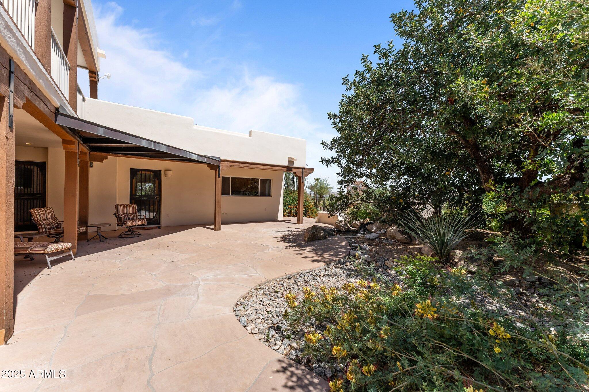 651 Chaparral Road Wickenburg, AZ 85390 - Photo 52 of 58 a view of a house with a patio