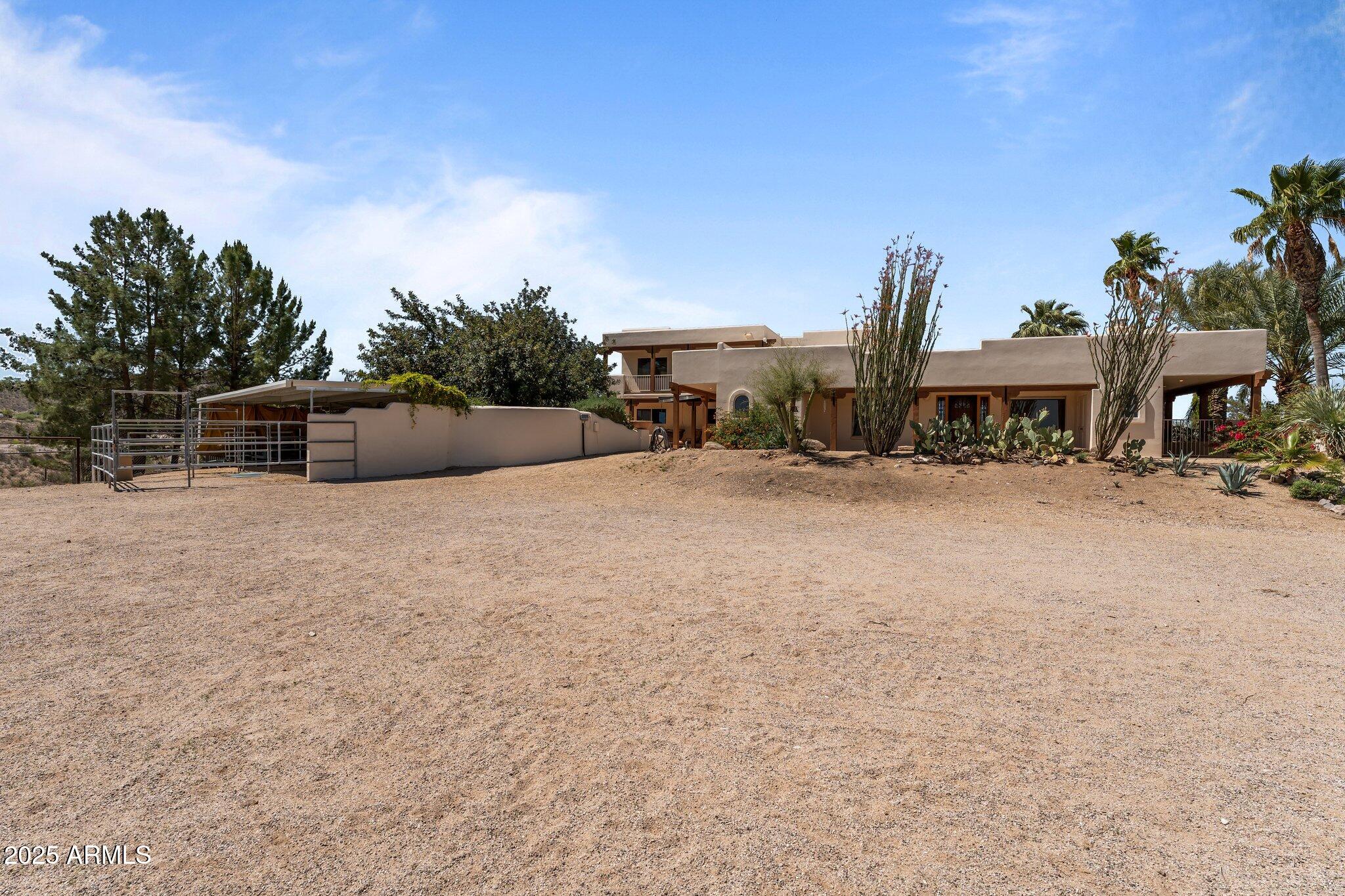 651 Chaparral Road Wickenburg, AZ 85390 - Photo 53 of 58 a view of swimming pool with outdoor seating and house in the background