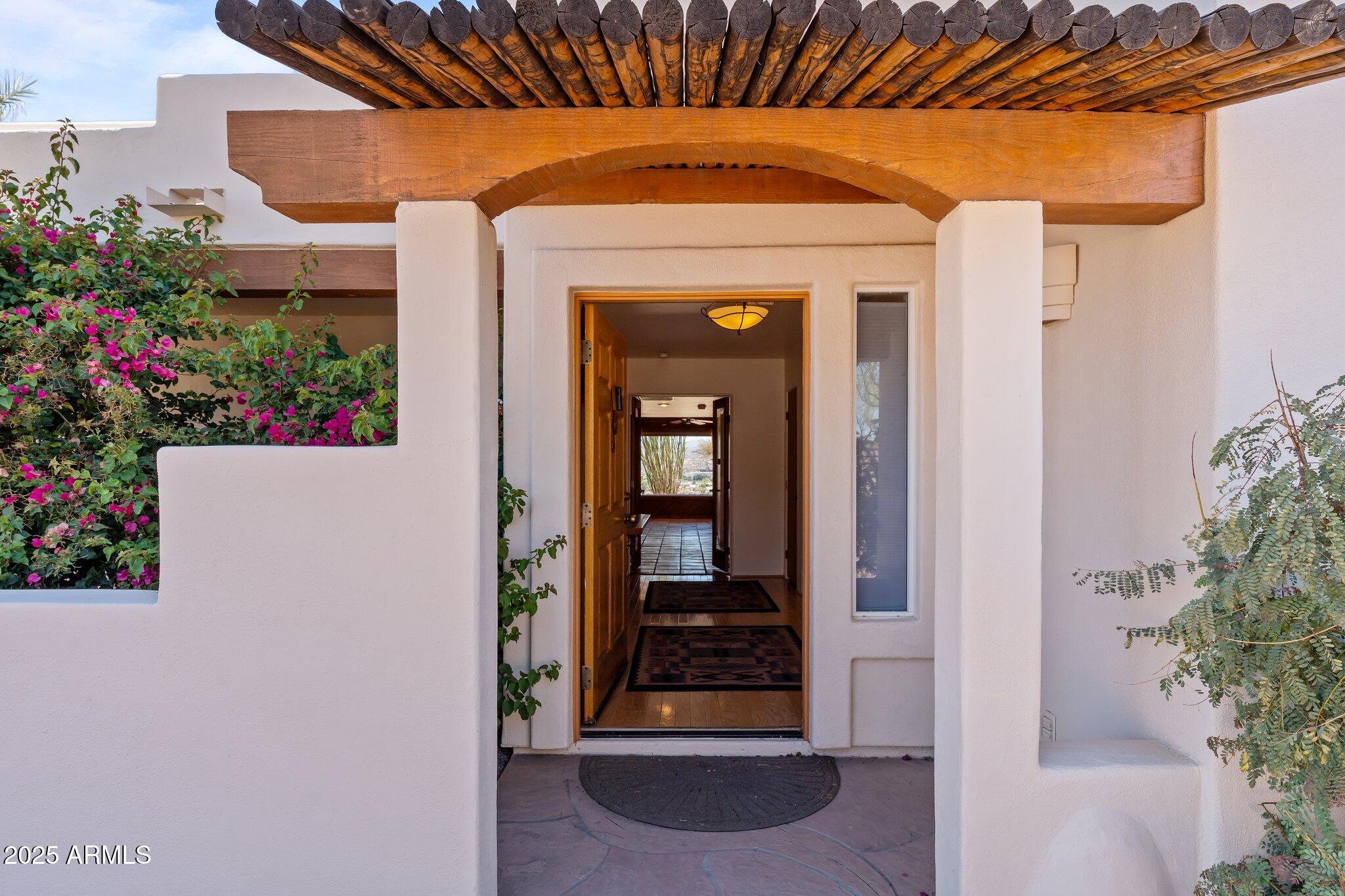 651 Chaparral Road Wickenburg, AZ 85390 - Photo 9 of 58 a front view of a house with a porch