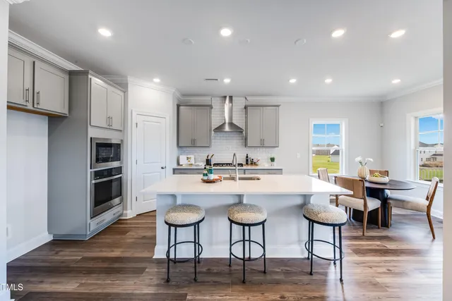 a kitchen with a sink stainless steel appliances and cabinets