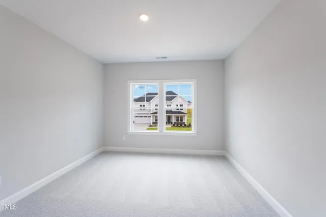 a view of an empty room and a window